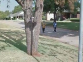 A screen grab of Google maps street view of Oklahoma City which allegedly shows two men who robbed a woman at her home in July 2011. (Google)