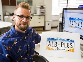 Derek Anton, creative director at Graphos, an Edmonton-based design firm, poses with the Alberta licence plate template that he came up with last week at the Graphos office in Edmonton, Alta., on Wednesday, July 16, 2014. Codie McLachlan/Edmonton Sun/QMI Agency