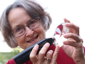 Gino Donato/The Sudbury Star   
Ruth Dibicki demonstrates a diamond tester on a fake diamond. The Sudbury Rock & Lapidary Society will be hosting its 32nd annual gem and mineral show this weekend at Carmichael Arena on Bancroft Drive.