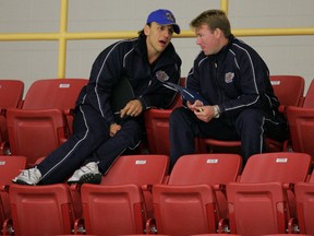 Edmonton Oil Kings' assistant coach Rocky Thompson (left) talks with head coach Steve Pleau during a practice in October of 2009.