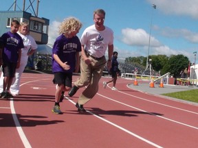 Mayor Jim Watson challenges Nathaniel Unrau, 12, to a race on Thursday, July 17, 2014 at the Terry Fox Athletic Facility after Athletics Canada announced Ottawa would host the 2017 and 2018 national track and field championships. JON WILLING/OTTAWA SUN