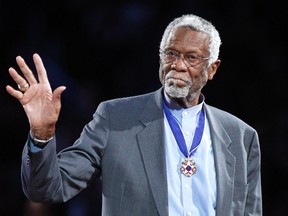 Boston Celtics' legend Bill Russell stands with his Presidential Medal of Freedom during the NBA All-Star basketball game in Los Angeles, February 20, 2011. (REUTERS/Danny Moloshok)