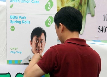 Chef Chip Tang puts up his menu for the Hong Kong Bakery during the opening day for Taste of Edmonton at Churchill Square in Edmonton, Alberta on July 17, 2014.  Perry Mah/Edmonton Sun/QMI Agency