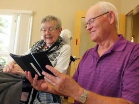 Al Graham helps set up Marshall Gowland Manor resident Catherine Fleischer on an eReader. A project through the Lambton County Library provided the hi-tech books for the nursing home. (BRENT BOLES, The Observer)