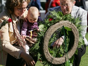 Margaret Galloway (right), widow of RCMP Cpl. Jim Galloway who was shot and killed earlier this year, lays a wreath along with other family members during the Alberta Police & Peace Officers' Memorial Day ceremony on the Alberta Legislature grounds in Edmonton, Alta., Sunday September 26, 2004. The ceremony commemorates Alberta police and peace officers who have died in the line of duty.
