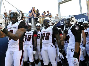 Ottawa Redblacks Jovon Johnson (L) and teammates prepare to enter the field against Winnipeg Blue Bombers before their CFL football game in Winnipeg, July 3, 2014. REUTERS/Fred Greenslade (CANADA - Tags: SPORT FOOTBALL)