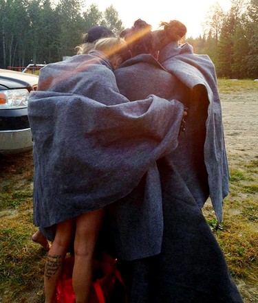 Six of the seven women hug as they stay warm under blankets after being rescued. They were in an inflatable boat Pembina River and it deflated. Edmonton Police Service's Air 1 helicopter was called to find them in the pitch black and then to help with their rescue. The seventh women was taken to hospital by Air 1. Photo supplied by/Dana Auld