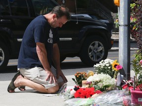 A man prays and is overcome with emotion as he attends the memorial site after Georgia Walsh was struck and killed by a vehicle in Leaside at Millwood Rd and McRae Dr. (Jack Boland/Toronto Sun)