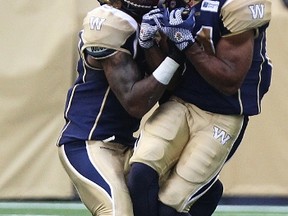 Paris Cotton & Demond Washington couldn't stay out of each other's way (KEVIN KING/Winnipeg Sun)