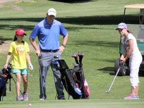 Chris Dickson, the Director of Golf Instruction at the Sarnia Golf and Curling Club, watches as participants in the Club's junior golf camp putt on the 6th green at the Holiday Inn Golf Course on Thursday, July 17. SHAUN BISSON/THE OBSERVER/QMI AGENCY