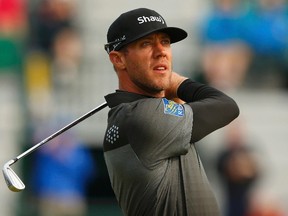 Graham DeLaet of Canada watches his tee shot on the fourth hole during the second round of the British Open Championship at the Royal Liverpool Golf Club in Hoylake, northern England July 18, 2014. (REUTERS/Cathal McNaughton)