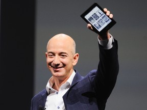 Amazon CEO Jeff Bezos holds up a Kindle Paperwhite during Amazon's Kindle Fire event in Santa Monica, California Sept. 6, 2012.  REUTERS/Gus Ruelas
