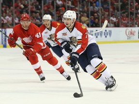 Dimitry Kulikov #7 of the Florida Panthers carries the puck across the blue line as Luke Glendenig #41 of the Detroit Red Wings follows during the second period of the game at the Joe Louis Arena on January 26, 2014 in Detroit, Michigan. (Leon Halip/Getty Images/AFP)