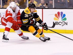Boston Bruins right wing Jordan Caron (38) skates with the puck as Detroit Red Wings defenseman Brian Lashoff (23) defends during the first period in game five of the first round of the 2014 Stanley Cup Playoffs. Mandatory Credit: Greg M. Cooper-USA TODAY Sports