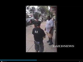 Eric Garner, right, is pictured in a video clip posted on the New York Daily News website. The image shows Garner just before he was tackled to the ground by New York police officers when they attempted to take him into custody. (nydailynews.com screengrab)