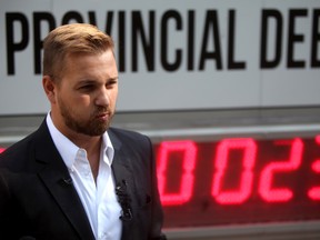 Canadian Taxpayers Federation Alberta Director, Derek Fildebrandt, is in front of the Debt Clock that the Canadian Taxpayers Federation's has launched at McDougall Centre in Calgary, Alta. on Monday July 14, 2014. Hugo Yuen/Special to the Calgary Sun
