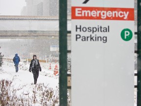 Pedestrians walk past the University of Alberta Hospital in Edmonton, Alta. (Ian Kucerak/Edmonton Sun/QMI Agency)