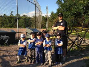 Pickering blastball coach Mike Nandlal stands with his team in front of the bleachers on the south diamond at Brock Ridge Park on Thursday. The aluminium benches from the bleachers were stolen earlier in the week. (IRENE THOMAIDIS/Toronto Sun)