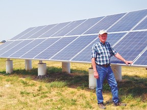 Glenn Logan stands by the solar panels at the family farm, called Wheatcrest Farms, near Lomond. The Vulcan Business Innovation Team bused a group of Vulcan County residents to the farm on July 16 to hear about the Logans' solar power setup as well as other technologies, including invisible fencing, GPS mapping and variable rate fertilizer application. Stephen Tipper Vulcan Advocate