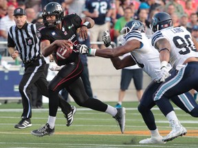 The Ottawa RedBlacks took on the Toronto Argonauts during their home opener at TD Place at Lansdowne Park in Ottawa Friday July 18,  2014. Ottawa RedBlack Henry Burris just missed getting tackled during first quarter action against the Argonauts Friday. Tony Caldwell/Ottawa Sun/QMI Agency