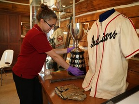 JOHN LAPPA/THE SUDBURY STAR/QMI AGENCYKaitlyn Kargus, a museum guide at the Anderson Farm Museum in Lively, ON., prepares an exhibition for the Creighton Mine Reunion 25th anniversary on Friday, July 18, 2014. The exhibition is located in a 1914 log cabin that was moved from Creighton to Anderson Farm Museum. Reunion activities will be held at the museum, as well as other locations in Lively on Saturday and Sunday.