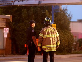 Firefighters respond to a fire in a courtyard between the former Billingsgate Fish Co. building, 7331 104 St., and 7341 - 104 Street, in Edmonton Alta., on Friday July 18, 2014. David Bloom/Edmonton Sun/ QMI Agency