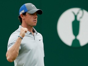 Rory McIlroy of Northern Ireland reacts after making his eagle putt on the 18th green during the third round of the British Open Championship at the Royal Liverpool Golf Club in Hoylake, northern England July 19, 2014.  (REUTERS)