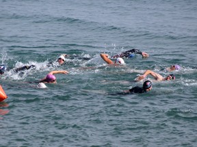 Competitors in the 2014 Bluewater Triathlon plunge into the water at the start of the sprint event on Saturday, July 19. SHAUN BISSON/THE OBSERVER/QMI AGENCY ​