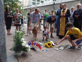 Mourners laid flowers and lit candles during a vigil at the Dutch embassy Saturday, July 19, 2014 for the 298 people who died when a commercial jet was shot down over Ukraine Thursday, July 17, 2014.
MEGAN GILLIS/Ottawa Sun/QMI AGENCY