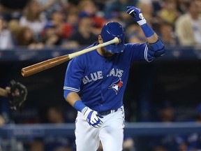 Blue Jays' Jose Bautista reacts after flying out in the fifth inning during against the Texas Rangers on Saturday in Toronto. (GETTY IMAGES)