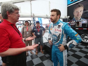 Toronto Sun contest winner Doug McInroy meets with Oakville's James Hinchcliffe prior to Saturday's washed out Race 1 at the Honda Indy Toronto. (Jack Boland/Toronto Sun)