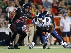Argos receiver John Chiles is tackled by an Ottawa RedBlacks defender on Friday night. (REUTERS)