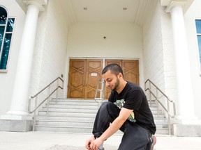 Anas El-khatib ties his shoelaces on the front steps of the London Muslim Mosque in London.  El-khatib will be running on August 9 to share his faith and raise money for the Unity Project. CRAIG GLOVER/The London Free Press/QMI Agency