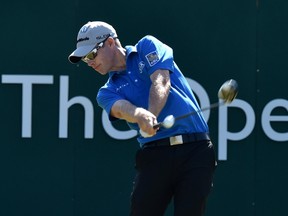 Canada's David Hearn plays his shot from the 1st tee during his first round on the opening day of the 2014 British Open Golf Championship at Royal Liverpool Golf Course in Hoylake, north west England on July 17, 2014. (AFP PHOTO / PAUL ELLIS)
