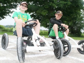 Brothers Daniel Schultz, 9, and Matthew Schultz, 10, check out some pedal cars in Lions Park in Hickson during Lions Daze hosted by the Lions club of Hickson on Saturday, July 19, 2014. The event included silent and live auctions, a breakfast on Saturday, a bike rodeo, co-ed lob ball tournament, firefighter demonstrations, a beef barbecue and a dance. JOHN TAPLEY/INGERSOLL TIMES/QMI AGENCY