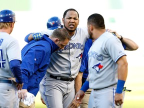 Blue Jays' Edwin Encarnacion leaves the field after injuring himself at first base during the first inning against the Oakland Athletics at O.co Coliseum. Encarnacion is "progressing well," according to general manager Alex Anthopoulos. (USA TODAY/PHOTO)