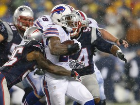 Buffalo Bills running back C.J. Spiller (28) runs the ball against New England Patriots cornerback Kyle Arrington (25) during the second quarter at Gillette Stadium. (David Butler II-USA TODAY Sports)