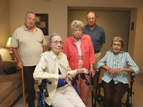 Residents of Homestead's Bowling Green III building, including, from left, Robert Smith, Jane Eby, Elaine Juby, Peter Tetro and Betty Dine, say the replacement of the building's elevator this summer will trap many of them in their upper-floor apartments for several weeks. 
ELLIOT FERGUSON/THE WHIG-STANDARD