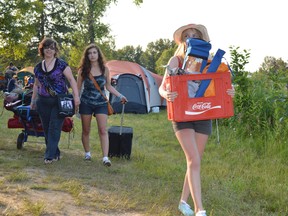 Jim Moodie/The Sudbury Star
Gina Brock of Sudbury and daughters Victoria and Emily lug gear and supplies to their campsite. Vehicles were not allowed within the camping areas this year in order to maintain a smaller environmental footprint and promote safety and exercise.