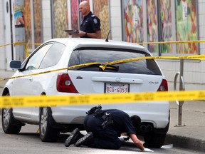 Police probe the area where a man was found dead Sunday. (Perry Mah/Edmonton Sun)