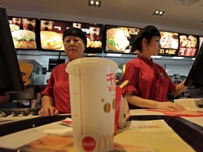 Employees serve food to customers at a McDonald's restaurant on Wangfujing shopping street in Beijing October 21, 2011. (REUTERS/Soo Hoo Zheyang)