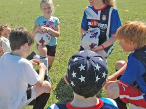 Laura McGinn, one of two soccer coaches at this year’s British Soccer Camp in Mitchell, speaks to kids about the sport.  KRISTINE JEAN/MITCHELL ADVOCATE