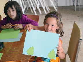 The Allied Arts Council offered free art courses for children during the summer. Catriona Gustavison, 5, shows off a page of the calendar she was working on. John Stoesser photos.