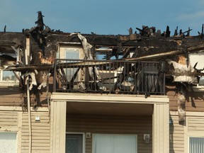 Damage is seen after an early morning fire in the Park Place South Hamptons at 1520 Hammond Gate in Edmonton Alta. on Monday, July 21, 2014. An improperly disposed cigarette is to blame for the blaze. Tom Braid/Edmonton Sun/QMI Agency