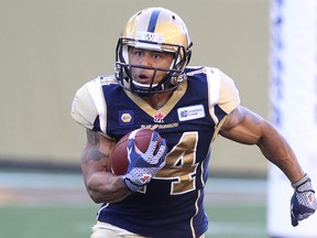 Winnipeg Blue Bombers KR Aaron Woods looks for a hole during CFL action against the Ottawa RedBlacks at Investors Group Field in Winnipeg, Man., on Thu., July 3, 2014. Kevin King/Winnipeg Sun/QMI Agency