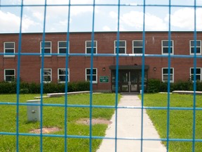 Building 55, one of the structures earmarked for demolition, is cordoned off with fencing at Wolseley Barracks last July. Today, a year after the military confirmed plans to level or sell eight buildings on the Oxford St. E. site, the first to go remains shuttered, but still standing. (Free Press File photo)