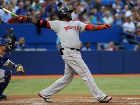 Boston Red Sox designated hitter David Ortiz follows through as he hits a two-run home run in the fourth inning against Toronto Blue Jays at Rogers Centre on Jul 21, 2014 in Toronto, Ontario, CAN. (Dan Hamilton/USA TODAY Sports)