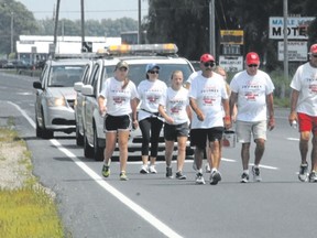 Bob Facca leads his team through St. Thomas Monday as he continues his 4,000-kilometre walk for Duchenne muscular dystrophy. (IAN McCALLUM, QMI AGENCY)