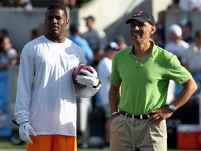 Miami Dolphins newly acquired free agent Mike Wallace (L) talks to Tony Dungy (R) before the Dolphins NFL/Hall of Fame Game against the Dallas Cowboys in Canton, Ohio August 4, 2013. (REUTERS/Aaron Josefczk)