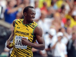 Jamaica's Usain Bolt celebrates after winning the men's 4x100 metres relay final at the 2013 IAAF World Championships at the Luzhniki stadium in Moscow on August 18, 2013.  (AFP PHOTO / KIRILL KUDRYAVTSEV)